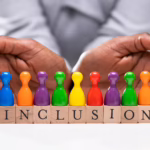 Inclusive language is shown with multiple colored pawn pieces with the word Inclusion below it and a hand safe-guarding it